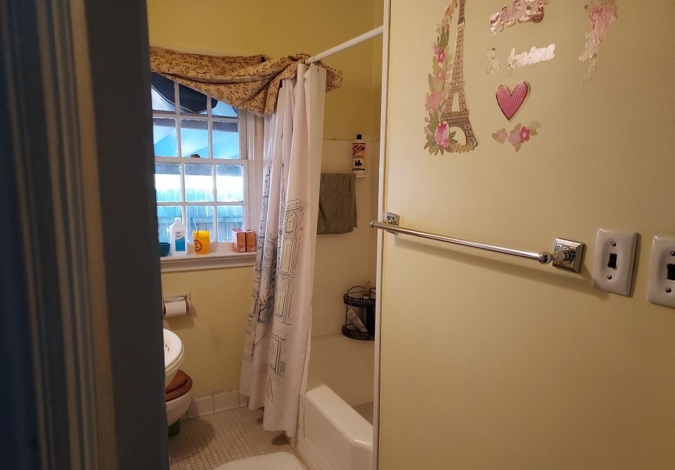 Bathroom before remodel — original yellow walls and dated fixtures