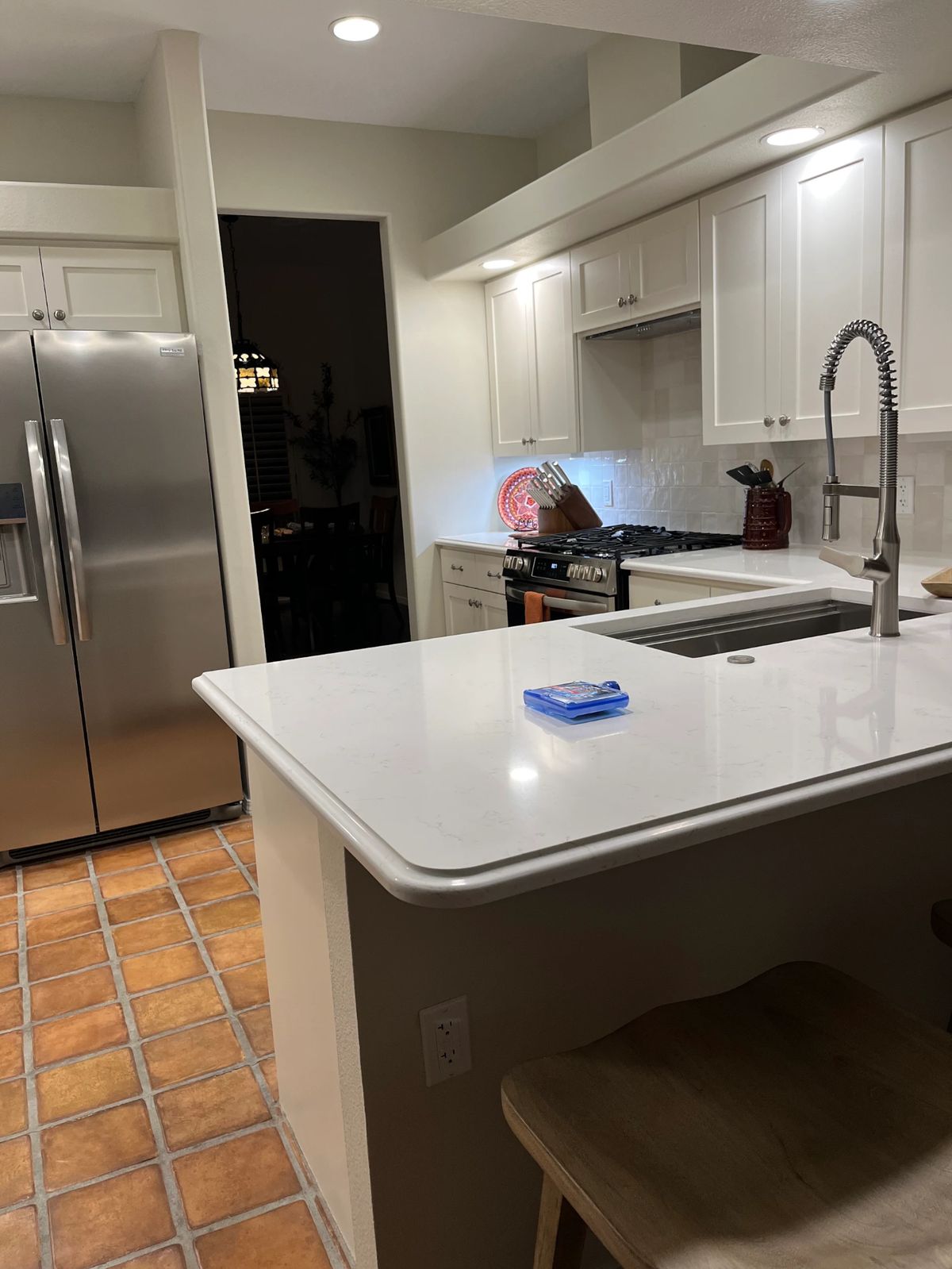 Completed kitchen remodel with white shaker cabinets and quartz countertops