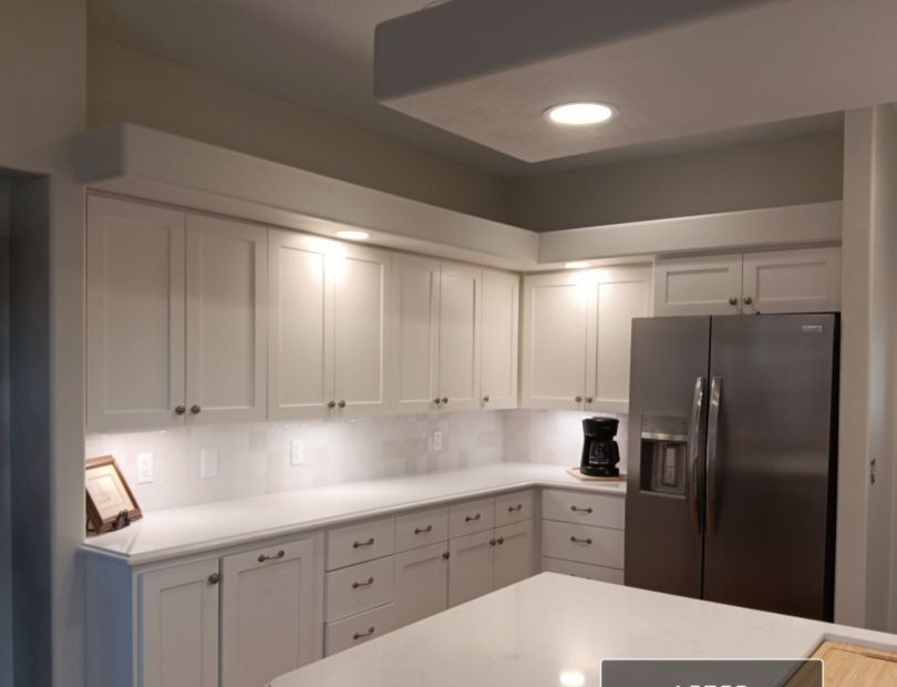 Kitchen after remodel — updated white cabinets and quartz countertops