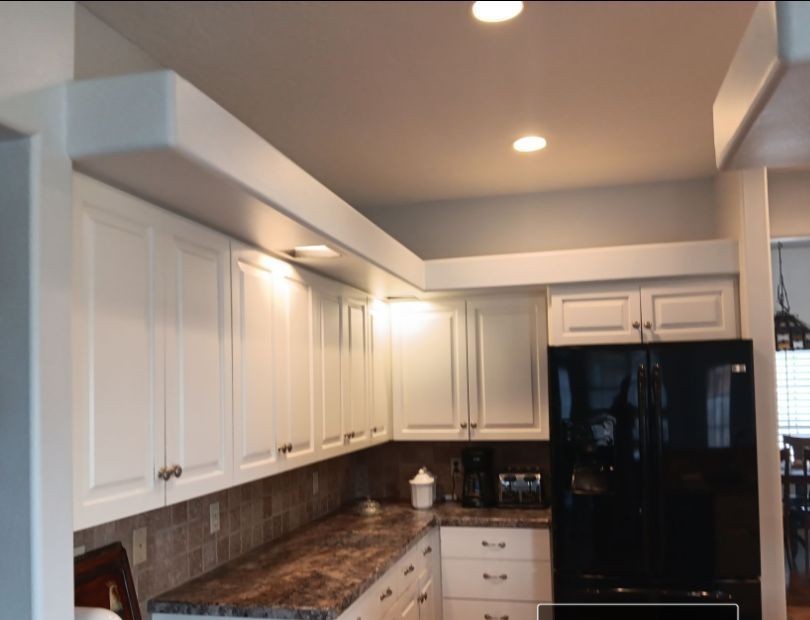 Kitchen before remodel — dated cabinets and laminate counters